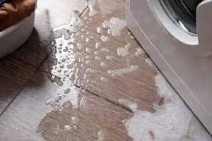Household washing machine, water with foam out onto the floor from below