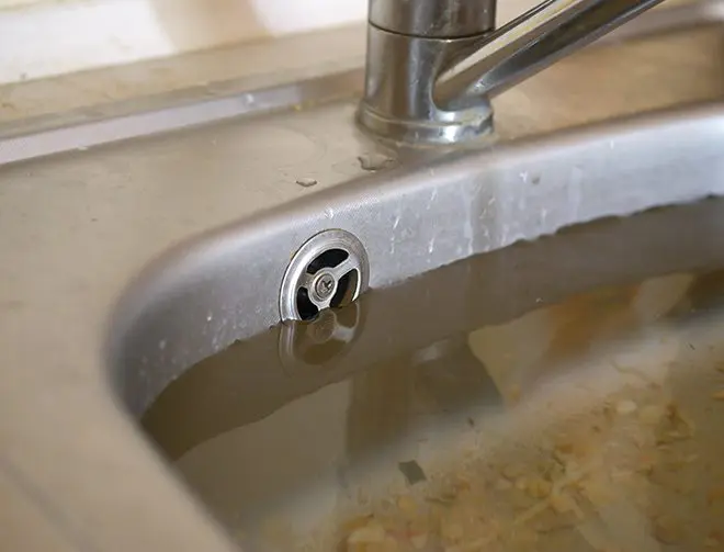 a sink with water filled to the top