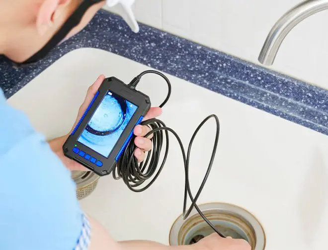 man testing the sewage drain in a sink