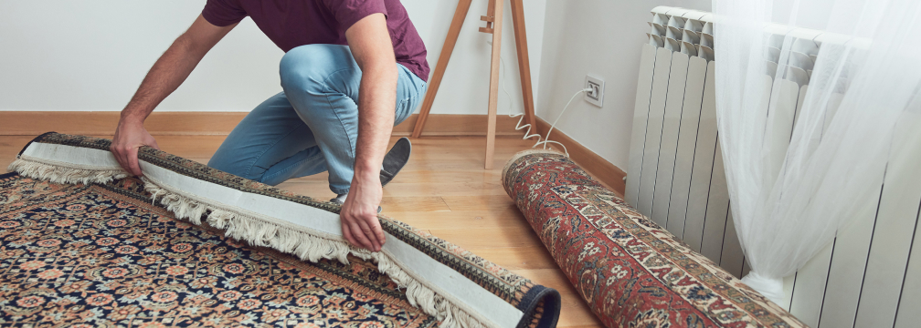 carpet-img-2 person rolling out area rug