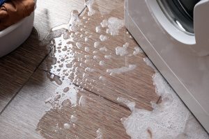Household washing machine, water with foam out onto the floor from below